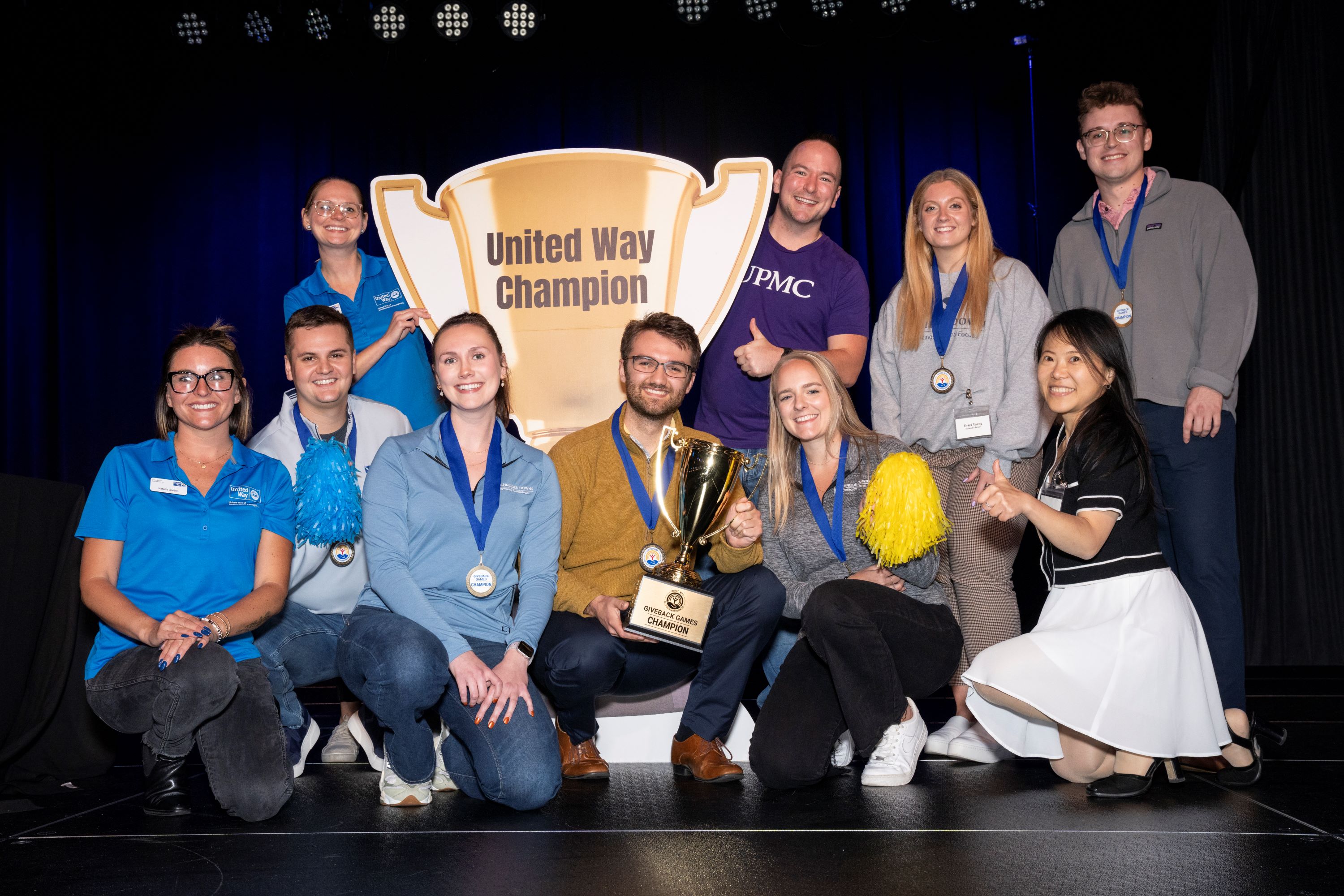 Winning Giveback Games team poses with trophy.