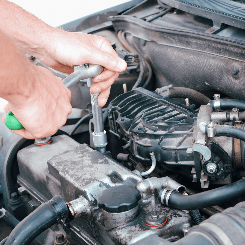 mechanic working on a car engine