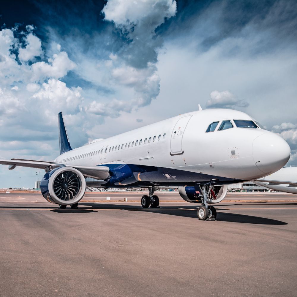 airplane on runway with clouds in the background