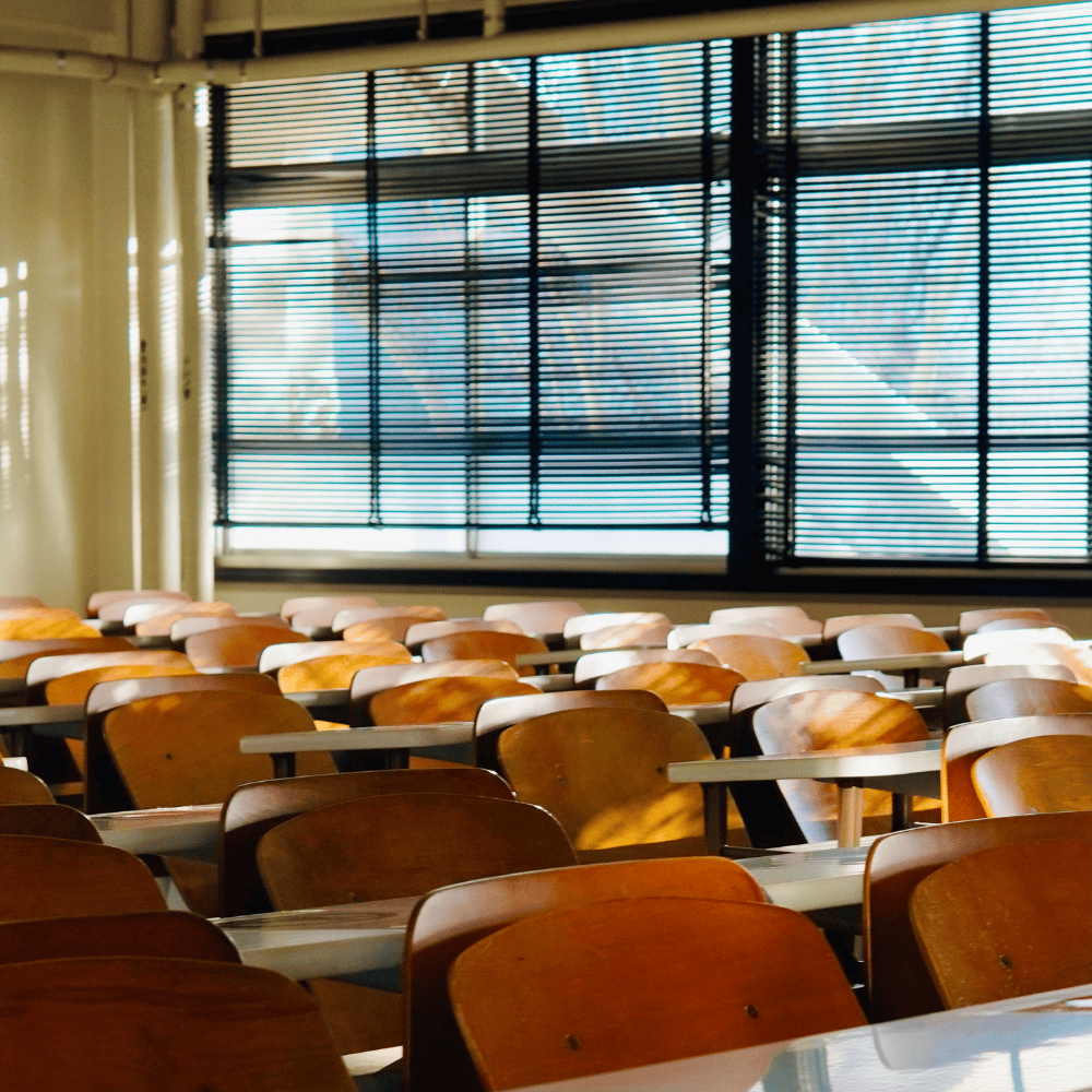 Rows of tables and chairs in a classroom.