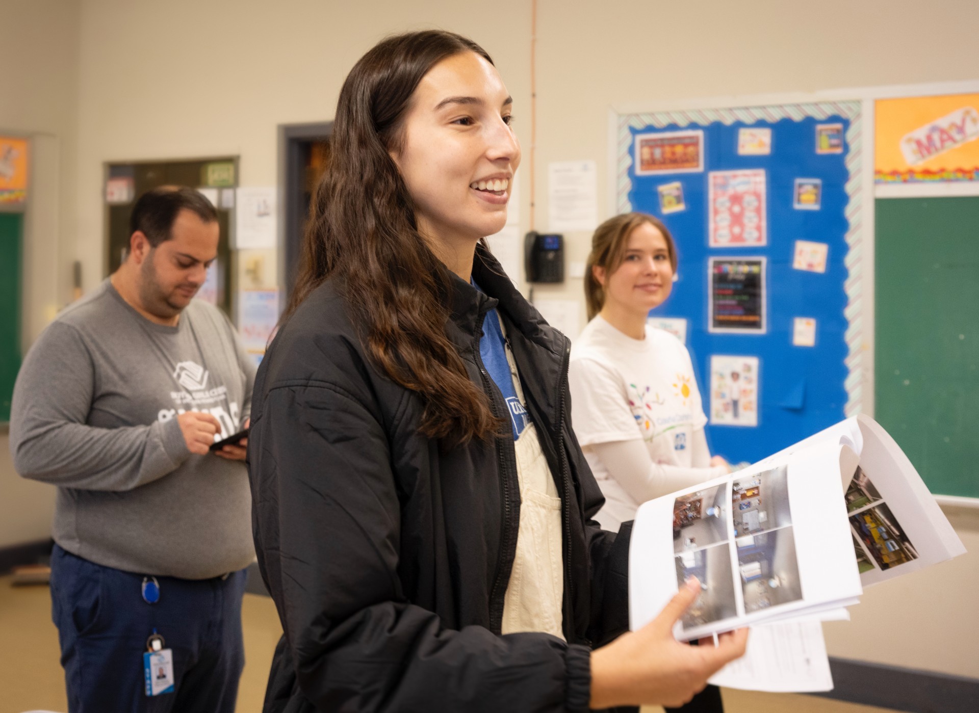 Camryn Lonchar speaking with two people in the background.