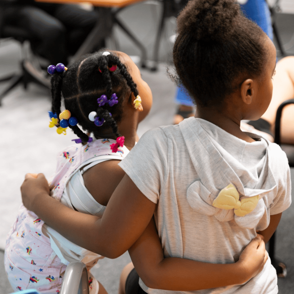 two young girls hugging
